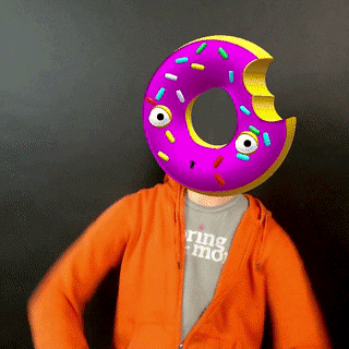 An augmented reality photo booth GIF of a guest with a purple donut prop