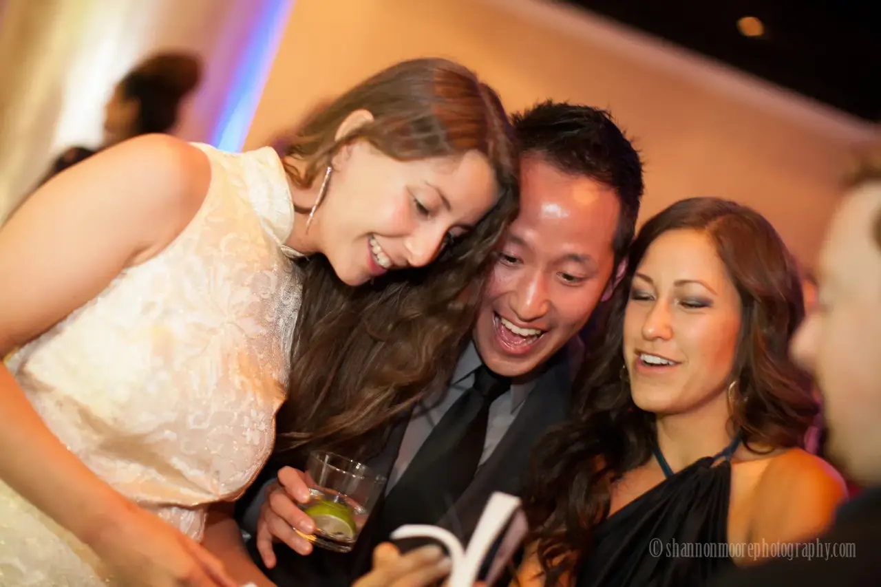 Guests laughing together as a SpotMyPhotos roaming photographer captures the moment at a gala